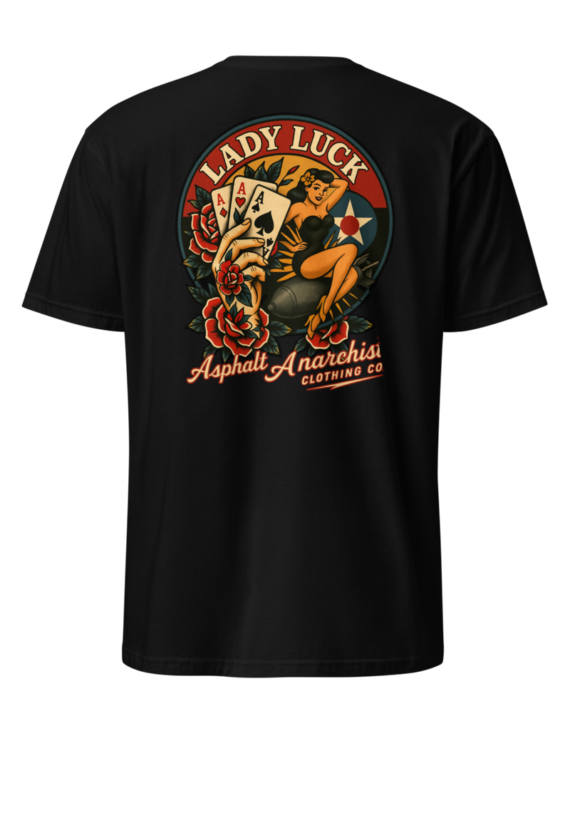 Back view of the Lady Luck black soft-style Tee from Asphalt Anarchist Clothing Co. The artwork showcases a WWII-style pin-up girl riding a bomb in mid-flight, flanked by traditional tattoo-style elements including a tattooed hand clutching three aces, and vibrant rose motifs. The graphic is rendered in classic Americana colors with subtle shading and crisp linework for a flash-art aesthetic. AI Generated Image.
