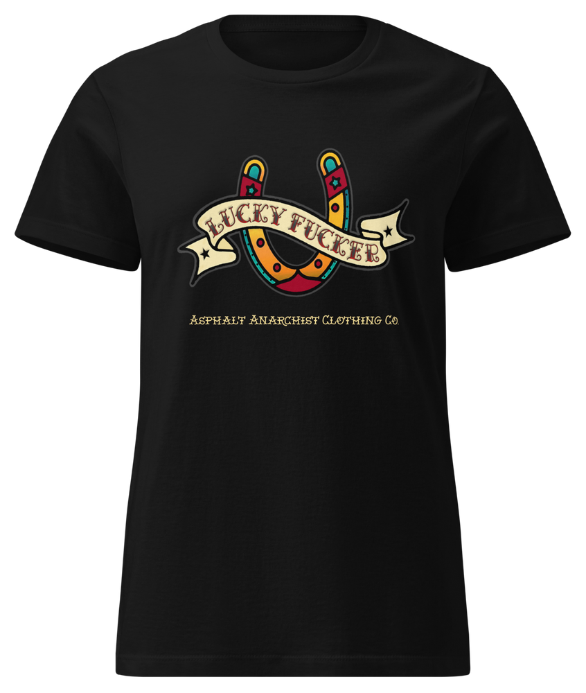 Front view of the Lucky Fucker Women’s Soft-Style Tee in black by Asphalt Anarchist Clothing Co. Front American traditional tattoo horseshoe & banner design with and subcultural swagger. AI Generated Image.