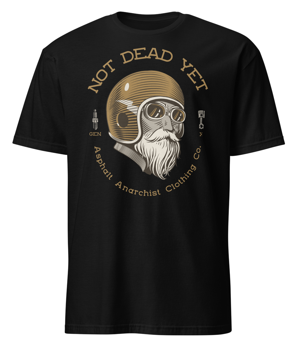 Front view of black t-shirt featuring bold ‘Not Dead Yet’ graphic with vintage lowbrow skull art and distressed lettering in a rebellious, hot rod style. Asphalt Anarchist Clothing Co. OLD SKOOL HOT ROD APPAREL Custom fueled, never factory filled. Image is AI-generated.
