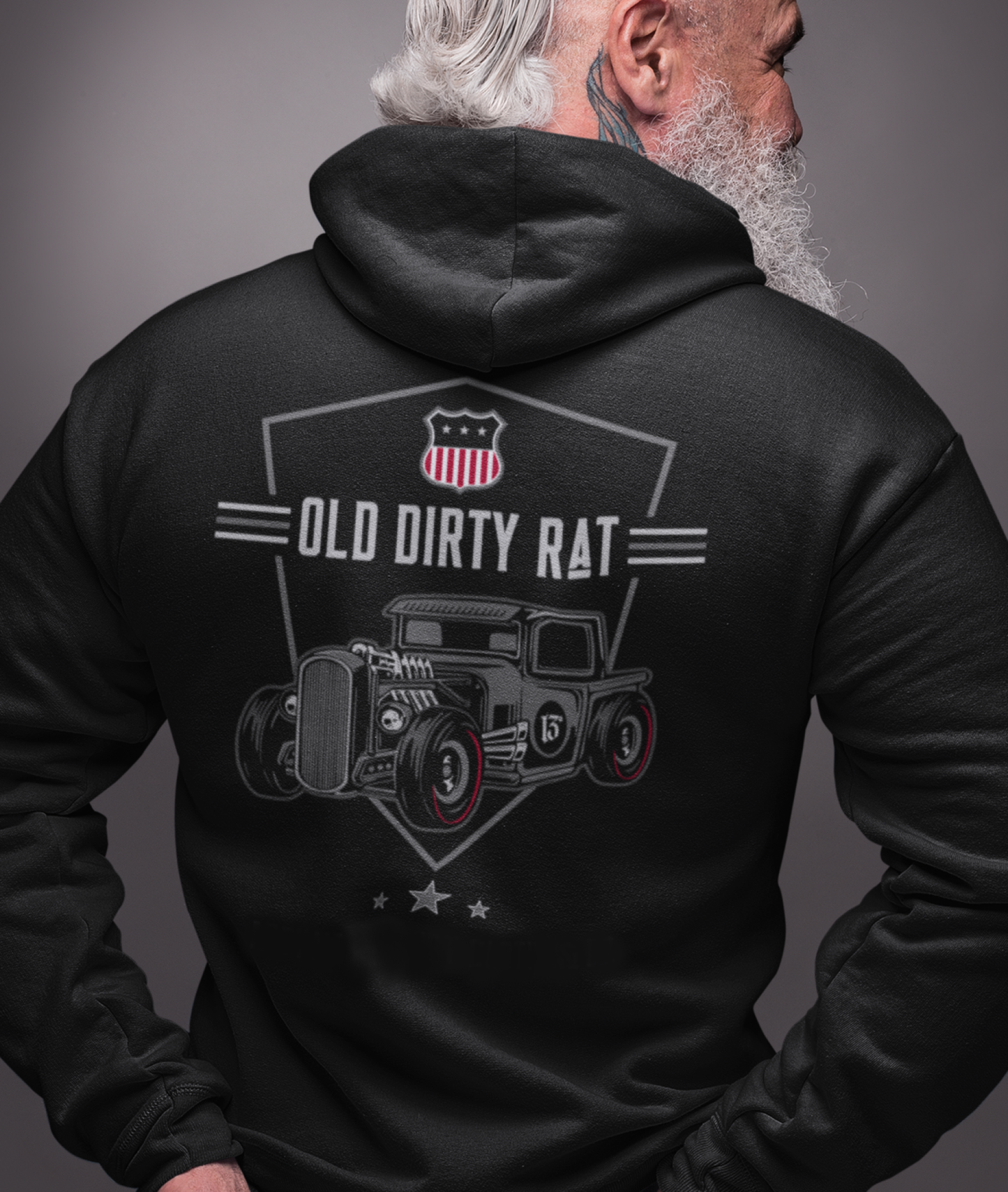 
                  
                    Back view of and old veterano biker with a white beard wearing the Old Dirty Rat Zipper Hoodie in black by Asphalt Anarchist featuring full‑back rat‑rod artwork and USA shield. AI Generated Image.
                  
                
