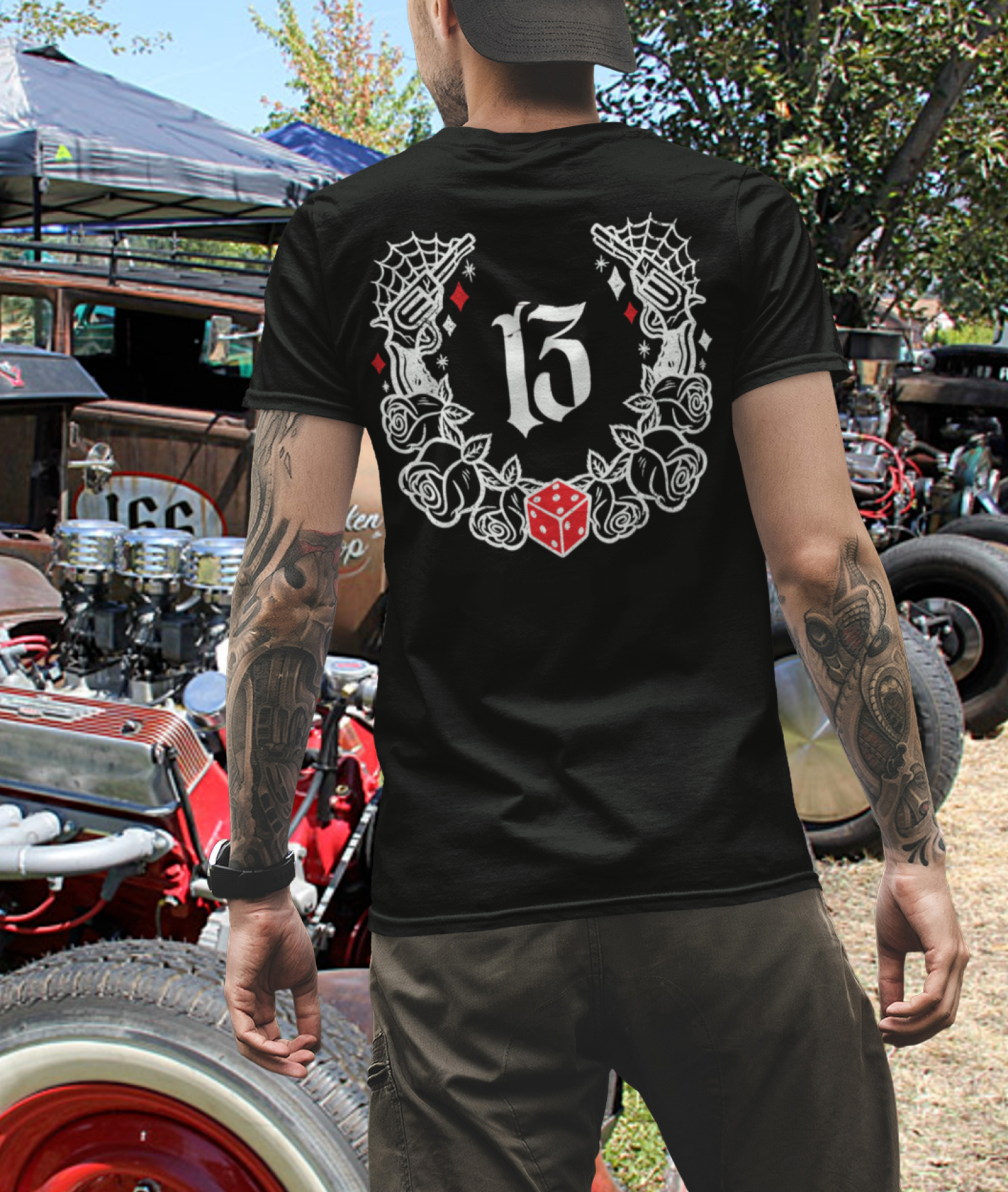 
                  
                    Back Collage View of the  “Big Iron” Tee in black by Asphalt Anarchist Clothing Co. worn by  rat rod guy at a car show —a raw, rebellious design steeped in old skool rat rod grit. This tee features cobwebs, a stylized number 13, tumblin' dice, crossed pistols, and classic roses—blended with gritty edge and vintage outlaw spirit. A true tribute to garage lore, lucky streaks, and hot metal attitude.
AI Generated Image
                  
                