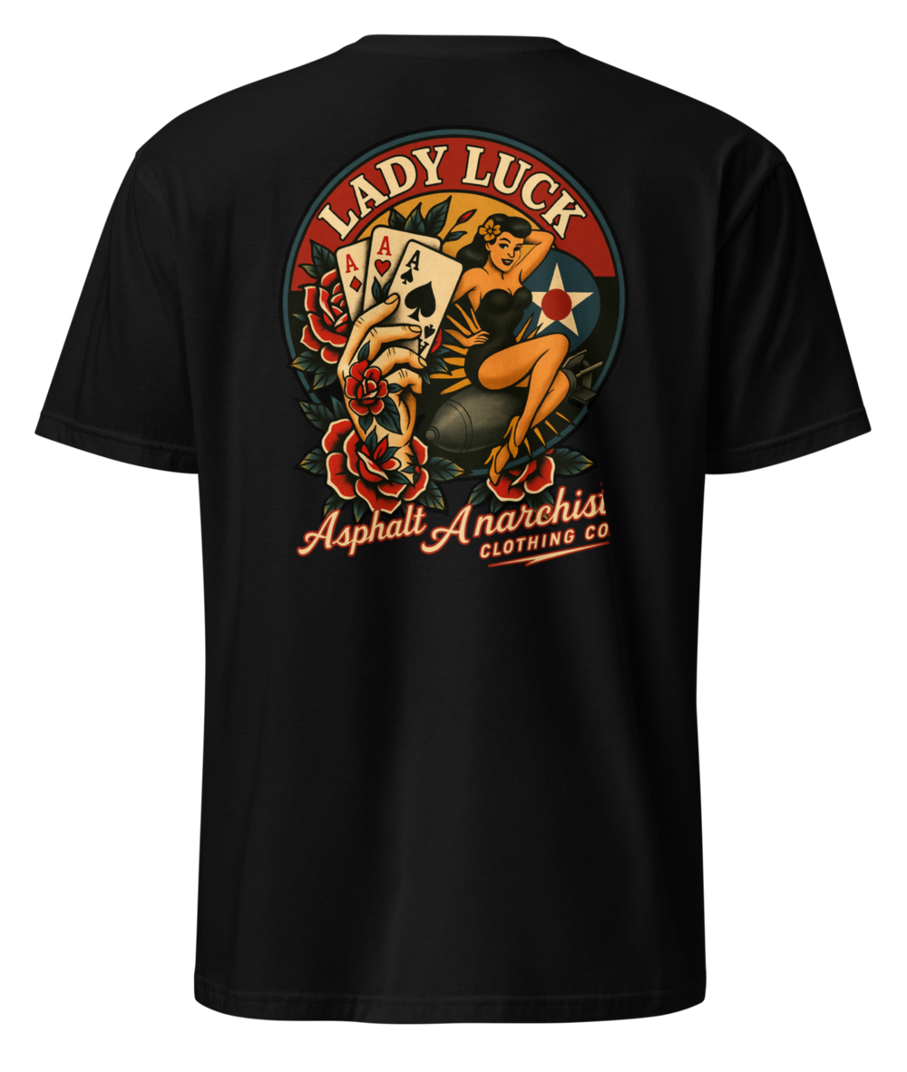 Back view of the Lady Luck black soft-style Tee from Asphalt Anarchist Clothing Co.  The artwork showcases a WWII-style pin-up girl riding a bomb in mid-flight, flanked by traditional tattoo-style elements including a tattooed hand clutching three aces, and vibrant rose motifs. The graphic is rendered in classic Americana colors with subtle shading and crisp linework for a flash-art aesthetic. AI Generated Image.